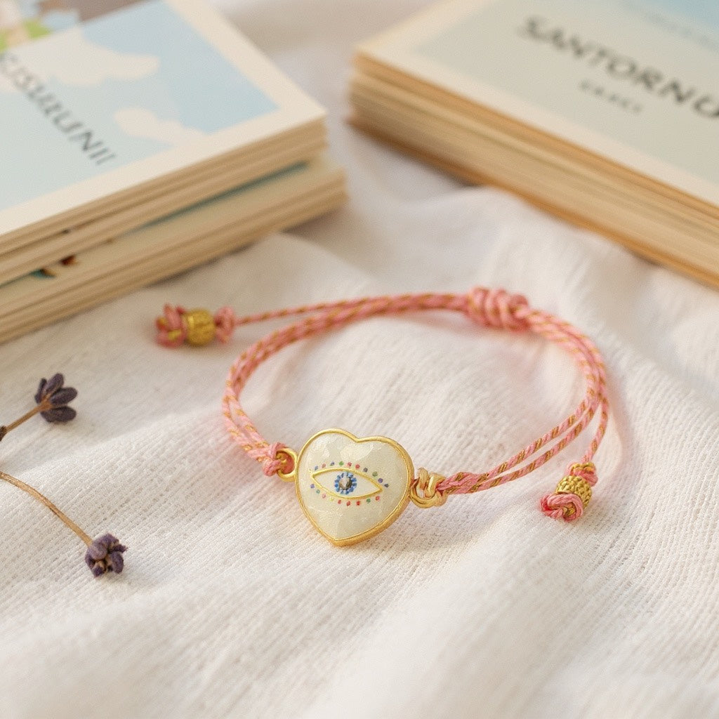 Pulsera de Mujer Hecha a Mano con Hilo Trenzado y Dije de Acero Inoxidable con Baño de Oro y Ojo Turco pintado